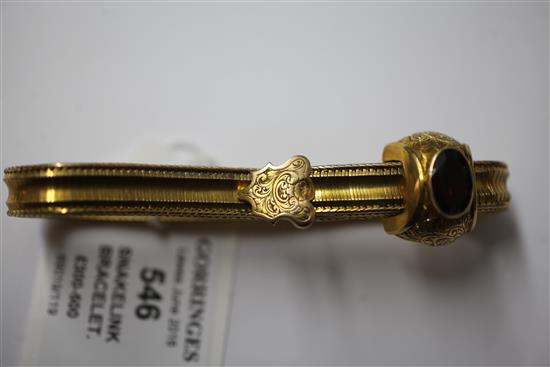 A Victorian gold and garnet snakelink slide action bracelet, gross 18 grams.